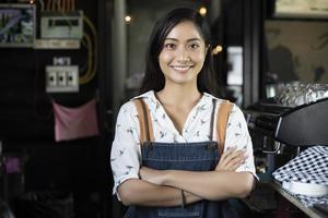 Asian women Barista smiling and using coffee machine in coffee shop counter - Working woman small business owner food and drink cafe concept photo