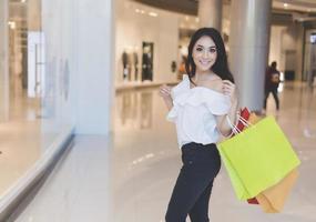 Asian women and Beautiful girl is holding shopping bags smiling while doing shopping in the supermarket