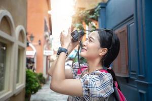 Asian women backpacks walking together and happy  are taking photo and selfie ,Relax time on holiday concept travel