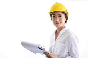 Asian women engineering inspecting and working and holding blueprints at office photo