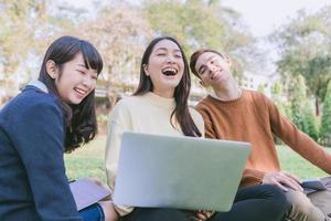 Group Students Smile and have fun It also helps to share ideas in the work and project. And also review the book before the exam in the garden. photo