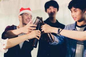 Asian group of friends having party with alcoholic beer drinks and Young people enjoying at a bar toasting cocktails.soft focus photo