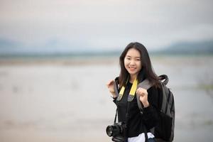 sian  young women people Hiking with friends backpacks walking together and looking map and taking photo camera by the road and looking happy ,Relax time on holiday concept travel