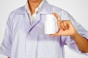 hand of doctor holding medicine bottle on white background photo