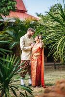 Asian bride and Caucasian groom have romantic time with Thailand dress photo