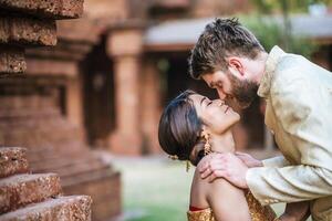 Asian bride and Caucasian groom have romantic time with Thailand dress photo