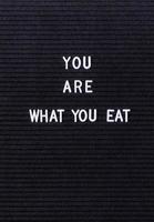 Black letter board with the words You Are What You Eat photo