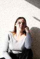 Portrait of a beautiful young woman with a shadow pattern on the face and body in the form of palm leaf photo