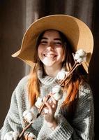 Retrato de una bella mujer joven con un sombrero de paja con un patrón de sombra en la cara y el cuerpo foto