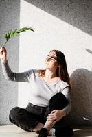 Portrait of a beautiful young woman with a shadow pattern on the face and body in the form of palm leaf photo