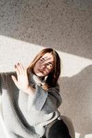 Portrait of a beautiful young woman with a shadow pattern on the face and body in the form of flowers photo