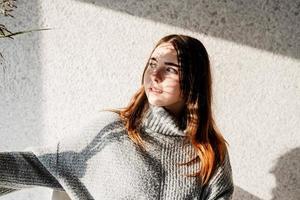 Portrait of a beautiful young woman with a shadow pattern on the face and body in the form of flowers photo