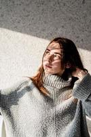 Portrait of a beautiful young woman with a shadow pattern on the face and body in the form of flowers photo