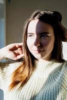 Portrait of a beautiful young woman with a shadow pattern on the face and body photo