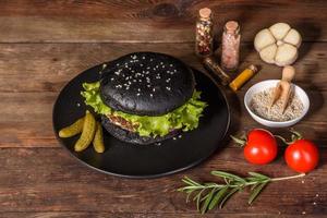 Tasty grilled homemade burger with beef, tomato, cheese, cucumber and lettuce photo