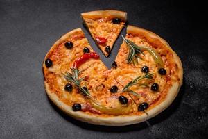 Tasty fresh hot pizza against a dark background. Pizza, food, vegetable, mushrooms photo