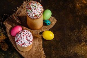 Easter cake and colorful eggs on a dark background photo