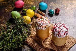 Easter cake and colorful eggs on a dark background photo