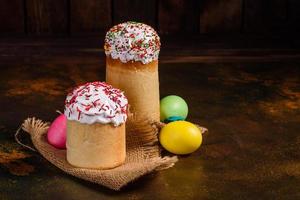 Easter cake and colorful eggs on a dark background photo