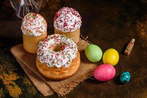 Easter cake and colorful eggs on a dark background photo