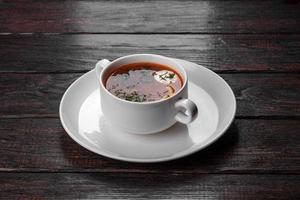 Appetizing dish of russian hodgepodge soup in ceramic pot photo