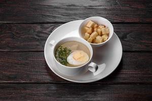 Asian noodle soup, ramen with chicken, vegetables and egg in white bowl photo