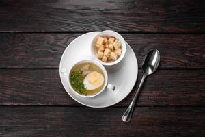 Asian noodle soup, ramen with chicken, vegetables and egg in white bowl photo