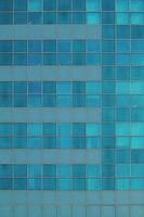 Blue glass wall of skyscraper. Office building windows. photo