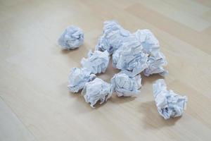 Crumpled paper on a wooden floor. Close up photo