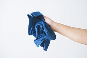 A cropped of man hand holding microfiber fabric on white background photo