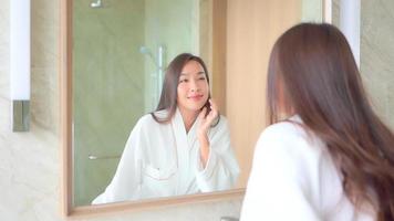 Young Asian woman check her face on mirror video