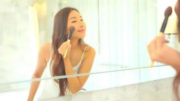 Young asian woman check her face on mirror video