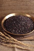 Riceberry rice in golden tray on table with a blank space for a text, riceberry rice in kitchen background photo