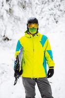 Man snowboarder in ski equipment photo