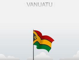 The Vanuatu flag is flying on a pole that stands tall under the white sky vector