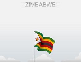 The Zimbabwe flag is flying on a pole that stands tall under the white sky vector