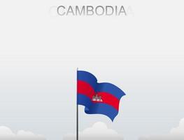 The Cambodia flag is flying on a pole that stands tall under the white sky vector