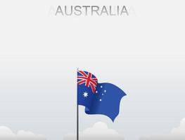 The Australia flag is flying on a pole that stands tall under the white sky vector