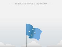 la bandera de los estados federados de micronesia ondea en un poste que se erige alto bajo el cielo blanco vector