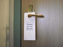 Please do not disturb sign on hotel room door photo