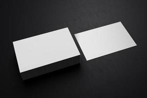 White horizontal business card paper mockup template with blank space cover for insert company logo or personal identity on black cardboard floor background. Modern concept. 3D illustration render photo