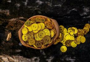 Gold coin in broken treasure jar photo