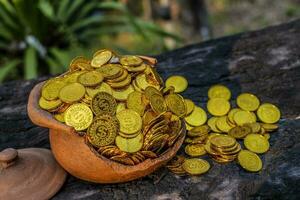 Gold coin in broken treasure jar photo