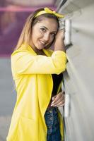 Young woman wearing a yellow jacket and headband photo