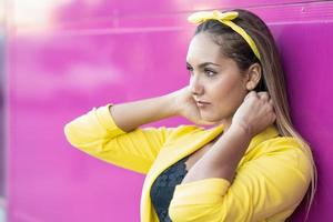 Young woman wearing a yellow jacket and headband photo