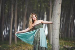 blonde woman wearing vintage dress in a poplar forest photo