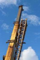 Elevator crane in blue sky low angle view photo