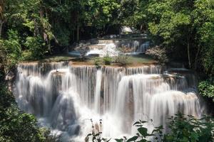 Huay Mae Khamin waterfall flowing in tropical rainforest on national park at Kanchanaburi photo