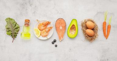 Ketogenic low carbs diet concept. Ingredients for healthy foods selection set up on white concrete background. photo