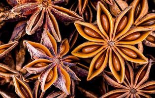 Chinese star anise close up background. Dried star anise spice fruits top view.